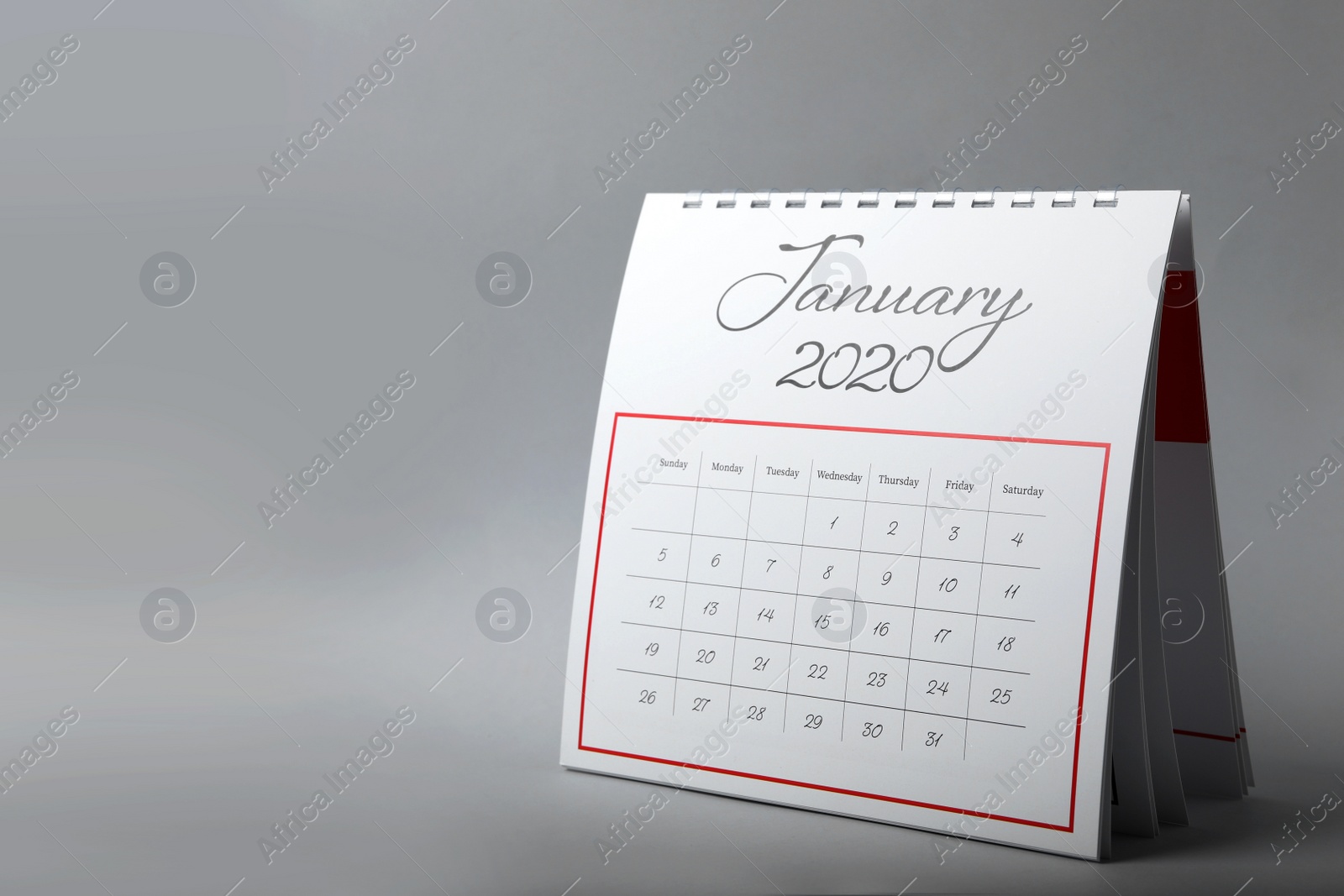 Photo of Paper calendar on grey background, space for text. Planning concept