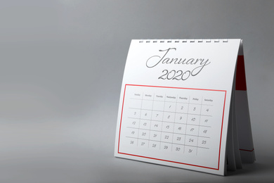 Paper calendar on grey background, space for text. Planning concept