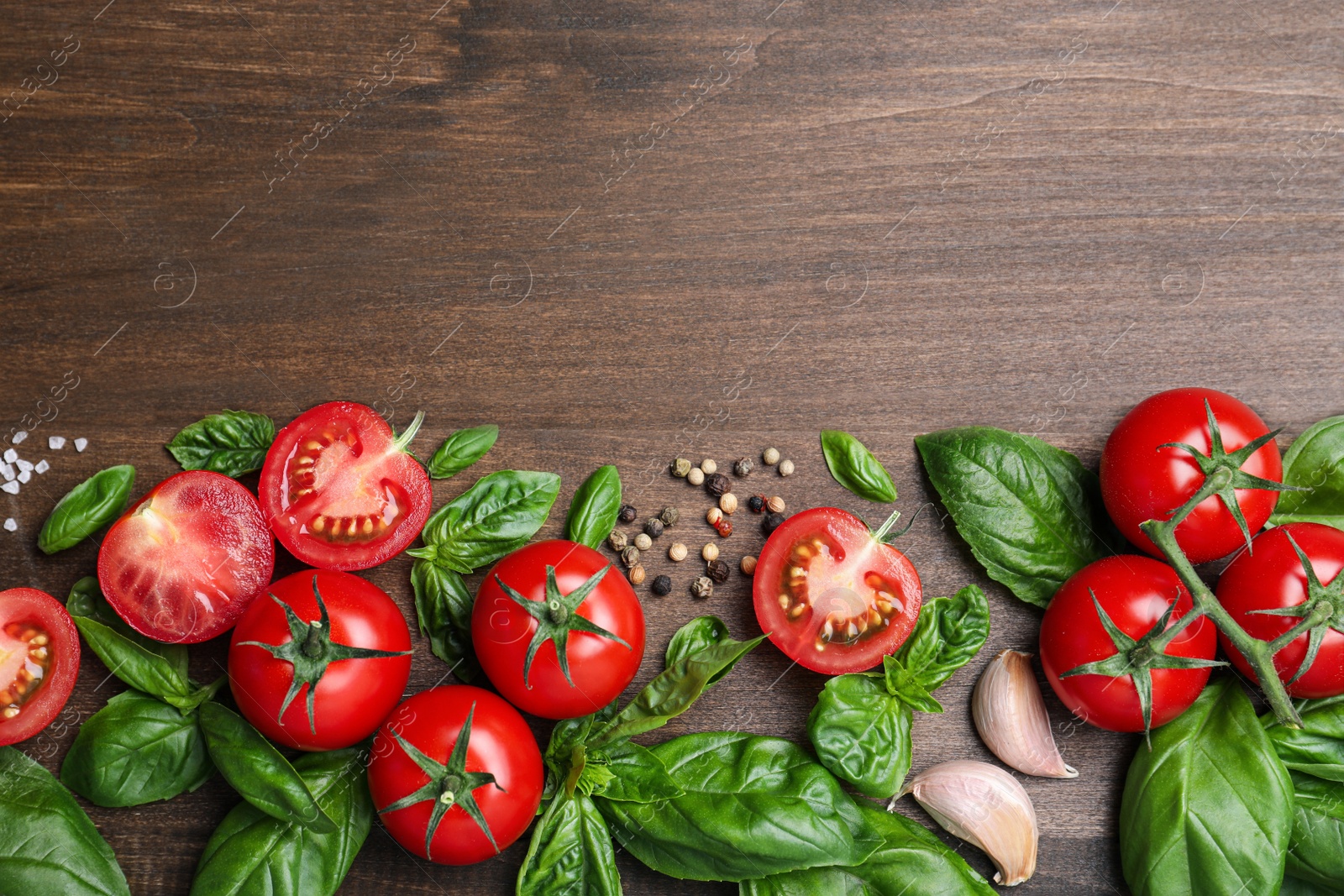 Photo of Flat lay composition with fresh basil leaves and vegetables on wooden table. Space for text