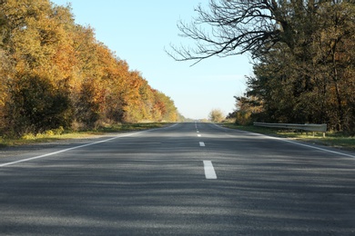 Photo of Asphalt road running through countryside on sunny day