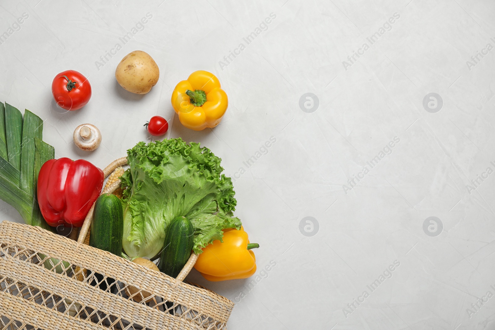 Photo of Fresh vegetables and other products on light grey background, flat lay. Space for text