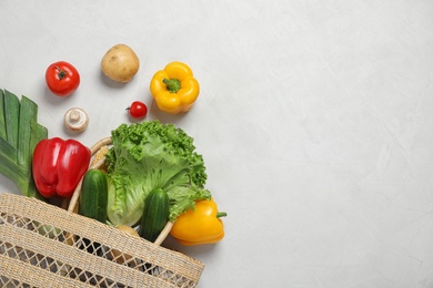 Fresh vegetables and other products on light grey background, flat lay. Space for text