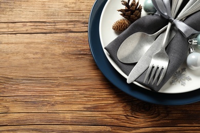 Photo of Beautiful Christmas table setting on wooden background, top view. Space for text