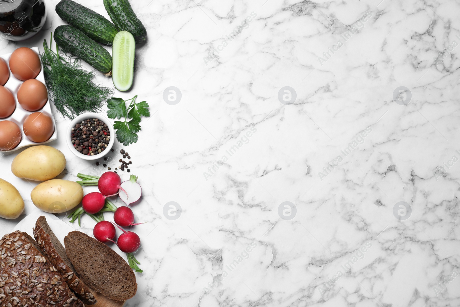 Photo of Flat lay composition of soup ingredients on white marble table, space for text. Traditional Russian summer okroshka