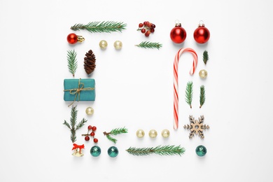 Photo of Flat lay composition with Christmas gift and festive decor on white background. Space for text