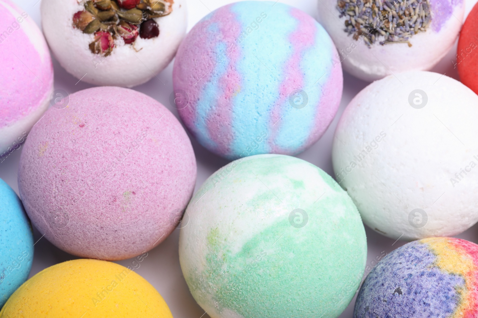 Photo of Colorful bath bombs on white background, above view