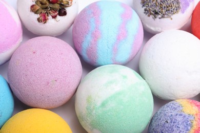 Photo of Colorful bath bombs on white background, above view