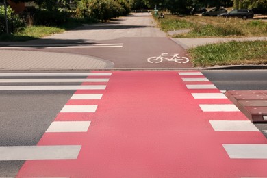 Photo of Bicycle lane with painted white sign and pedestrian crossing outdoors