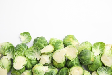 Photo of Fresh Brussels sprouts on white background, top view. Space for text