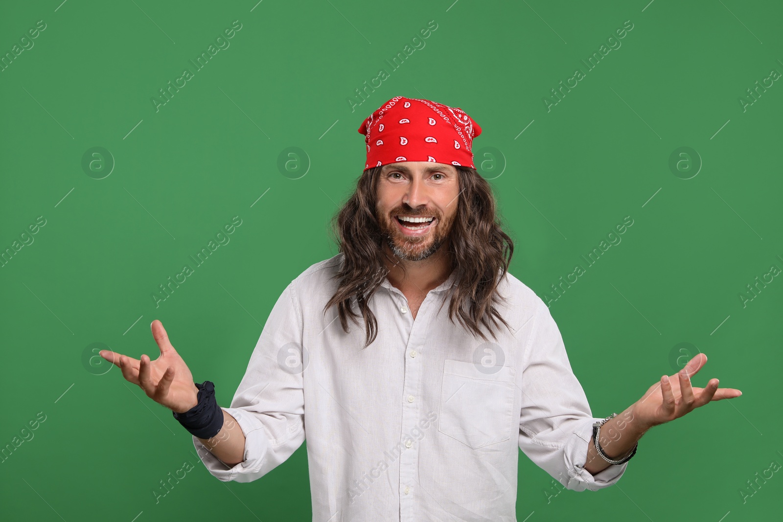 Photo of Stylish hippie man in white shirt on green background