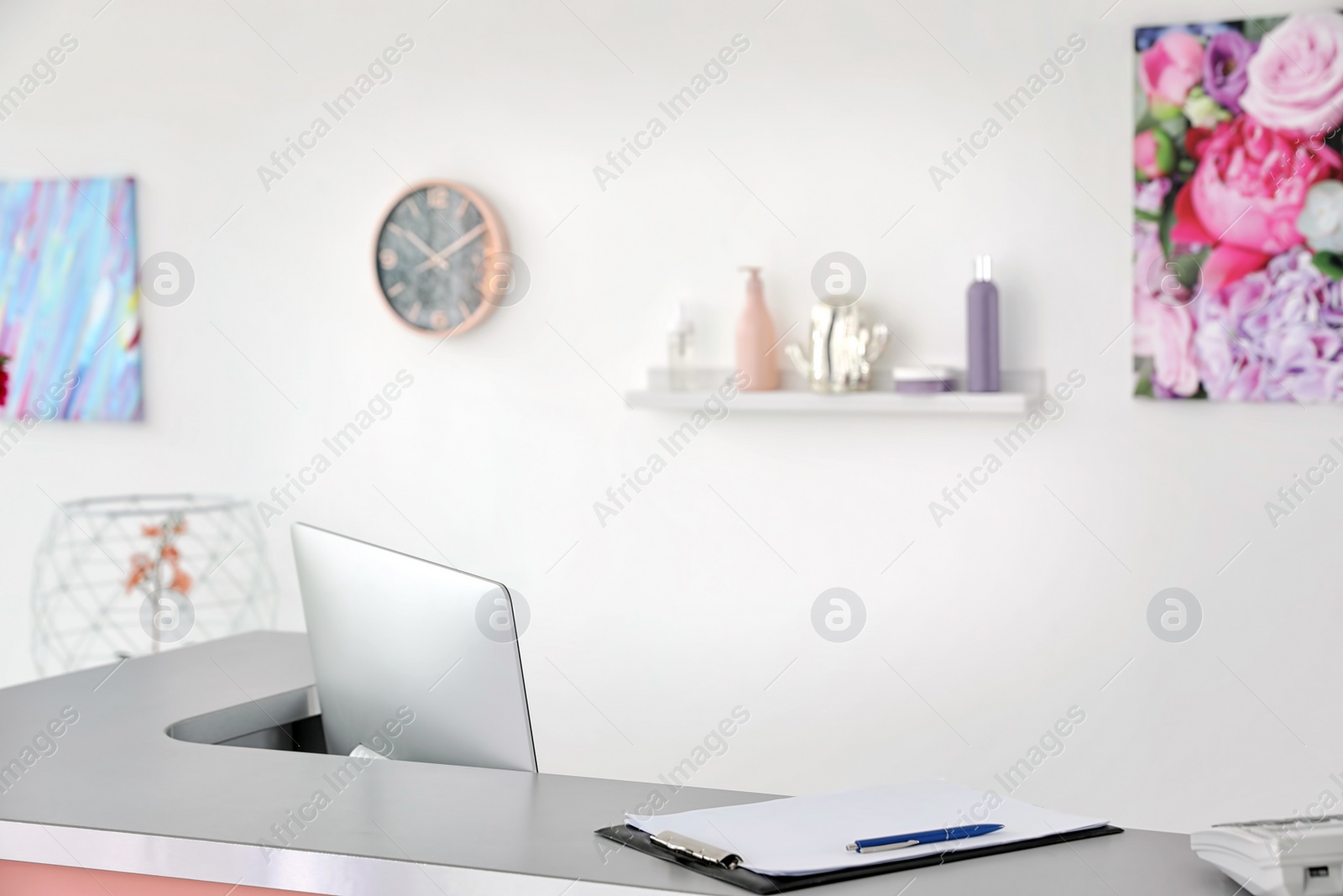 Photo of Beauty salon interior with computer on desk. Receptionist workplace