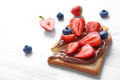 Photo of Toast bread with strawberry and blueberry on light background, closeup