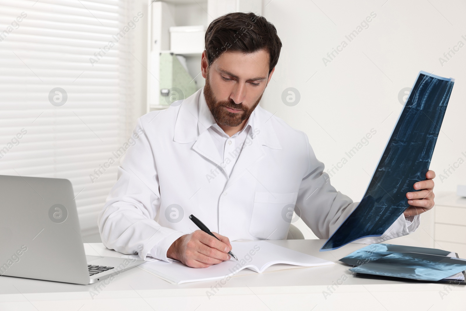Photo of Doctor writing results from MRI scan in hospital