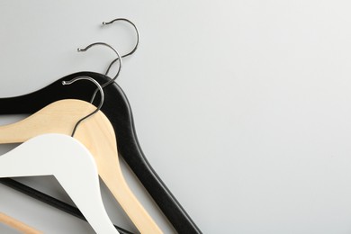 Photo of Hangers on light gray background, top view. Space for text