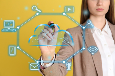 Cloud technology concept. Woman with marker on yellow background, closeup