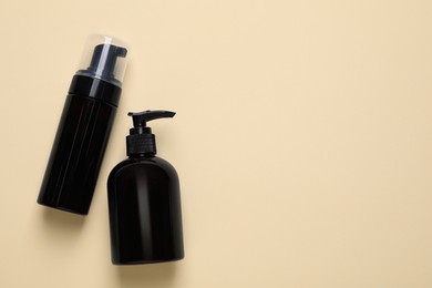 Photo of Different cleansers on beige background, flat lay with space for text. Cosmetic product