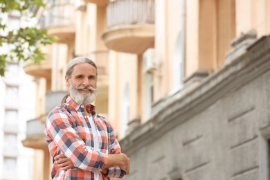 Portrait of handsome bearded mature man, outdoors