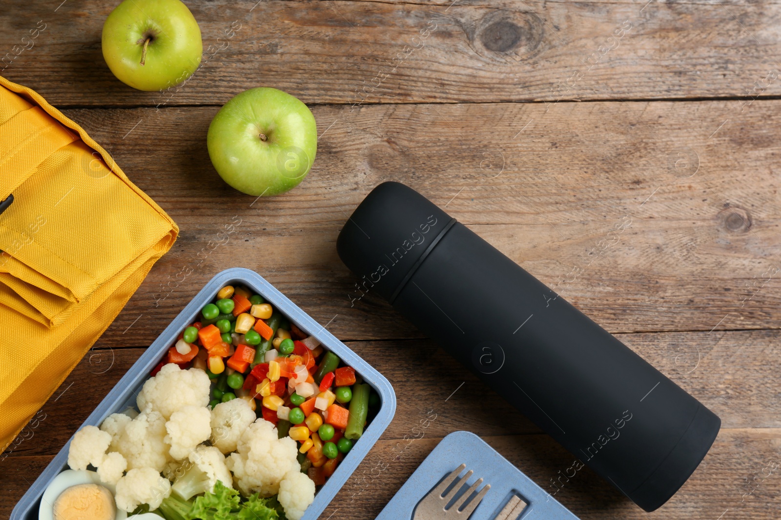Photo of Flat lay composition with thermos and food on wooden table. Space for text