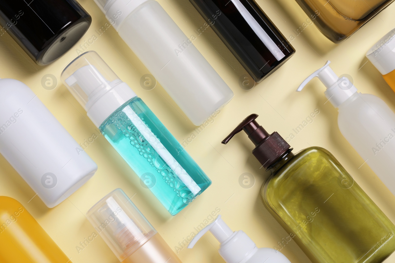 Photo of Different cleansers on beige background, flat lay. Cosmetic product