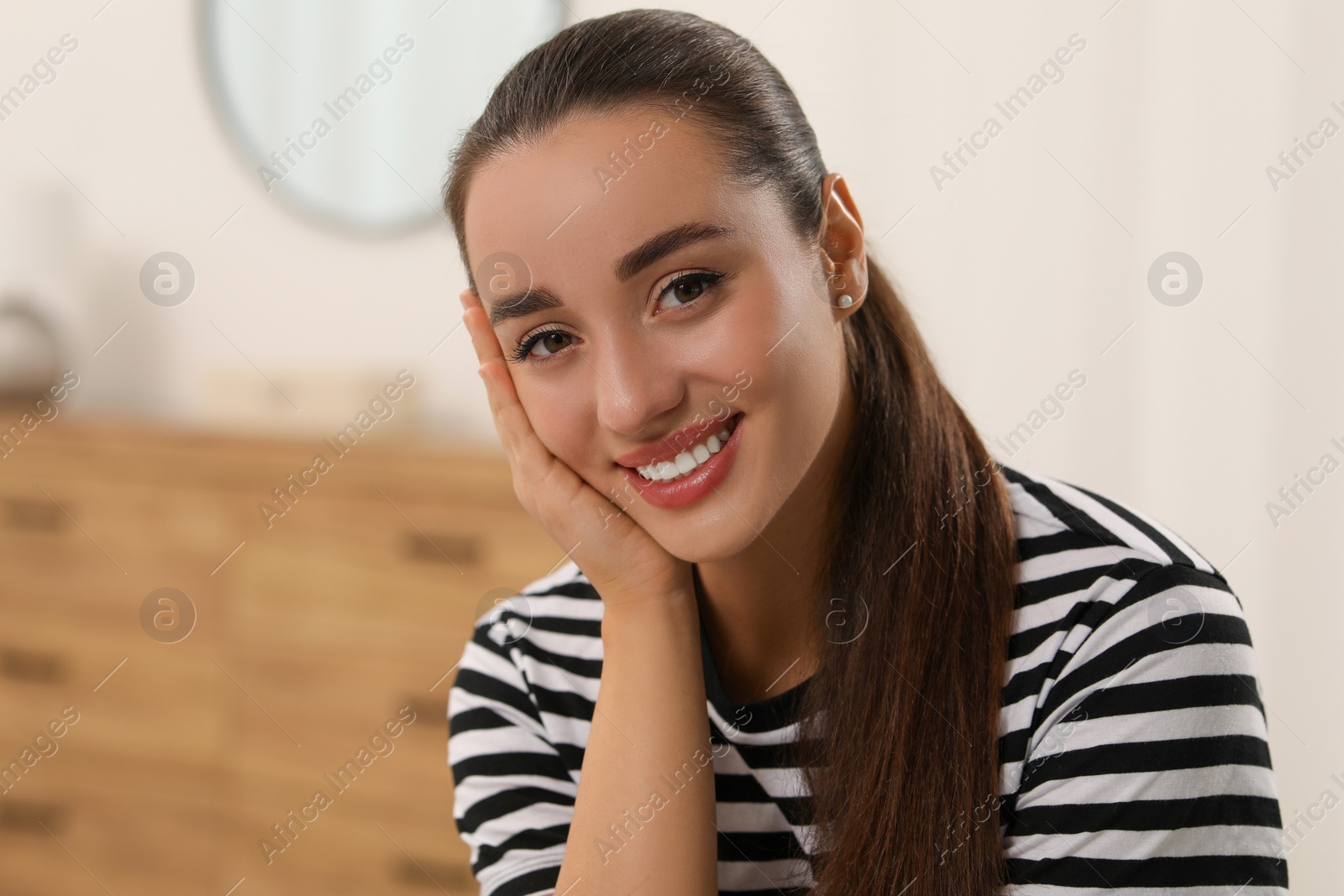 Photo of Portrait of beautiful young woman indoors, space for text. Attractive lady smiling and looking into camera