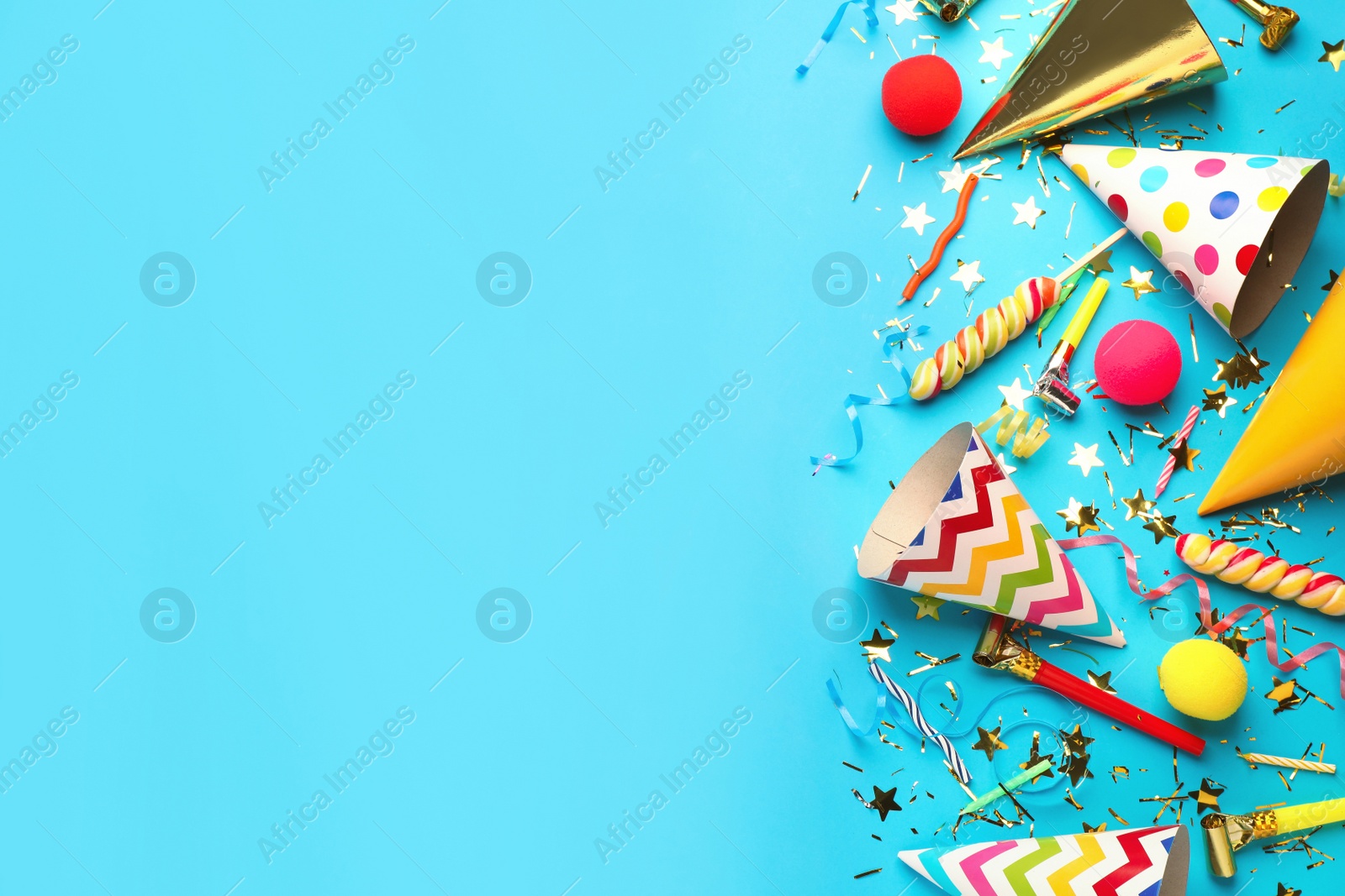 Photo of Beautiful flat lay composition with festive items on light blue background, space for text. Surprise party concept