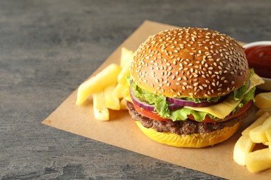Photo of Burger with delicious patty and french fries on table, closeup