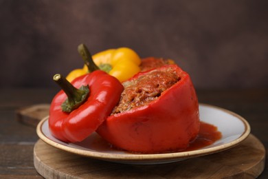 Photo of Delicious stuffed bell peppers served on wooden table