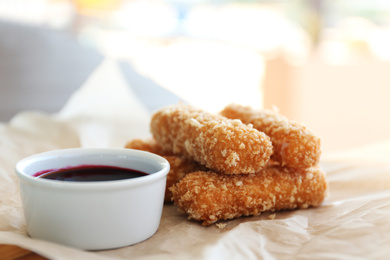 Photo of Fried cheese sticks and sauce on parchment