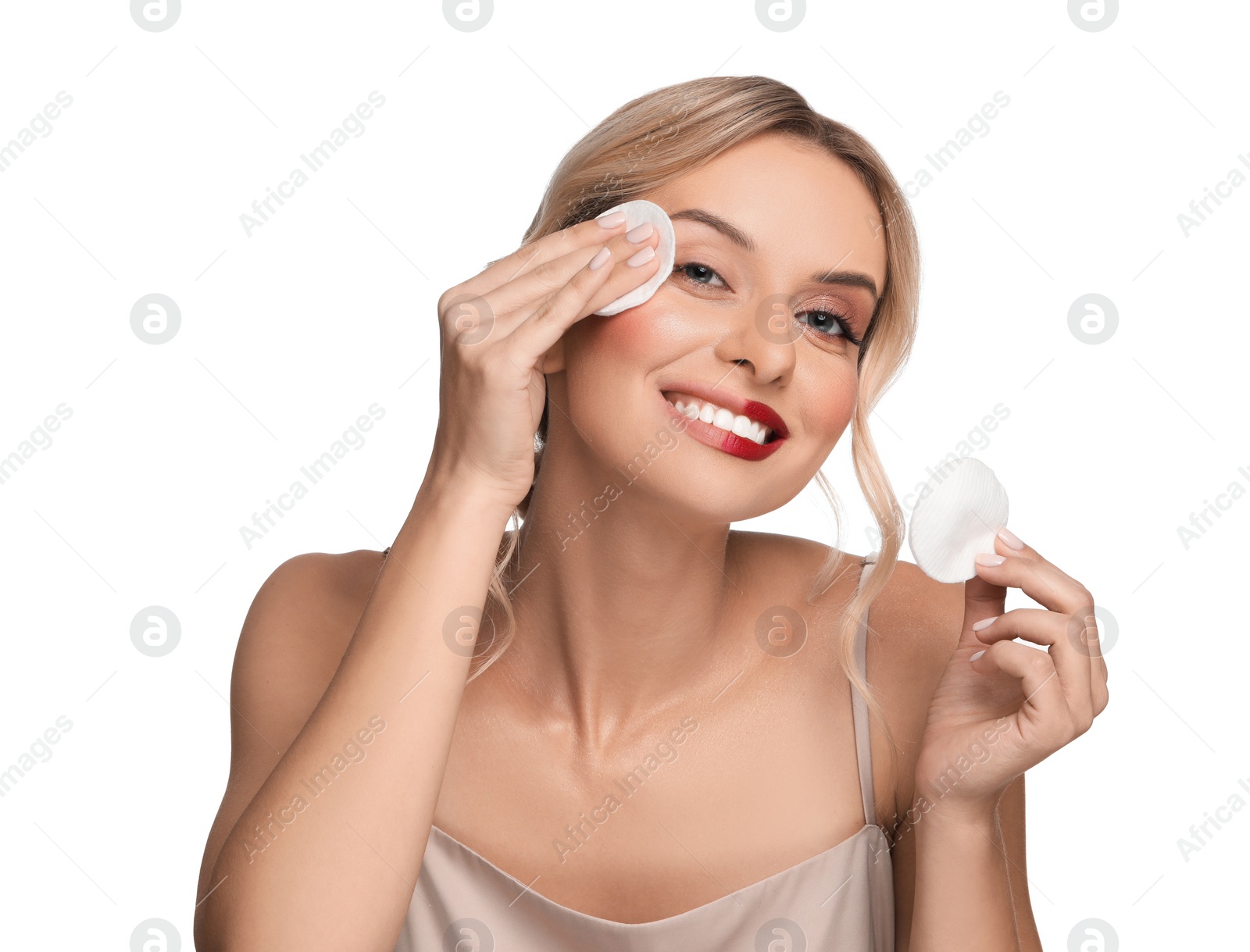 Photo of Smiling woman removing makeup with cotton pads on white background