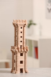 Wooden tower on table indoors, closeup. Children's toy