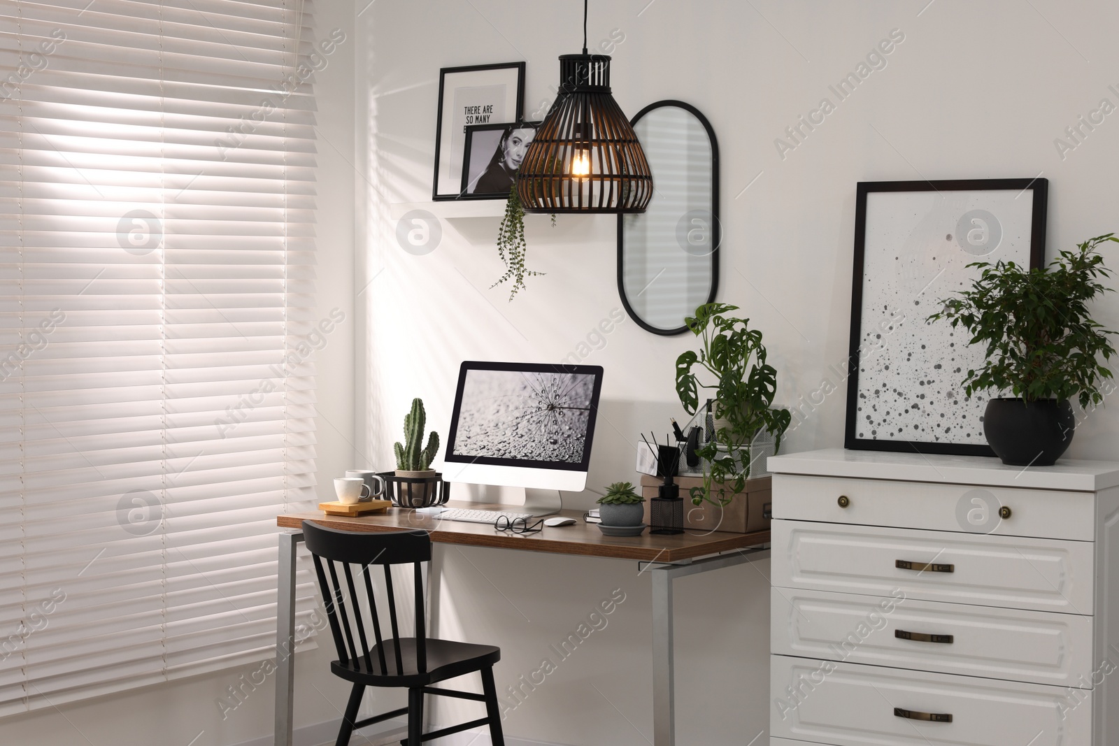 Photo of Cozy workspace with computer on wooden desk at home