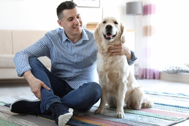Photo of Portrait of owner with his friendly dog at home