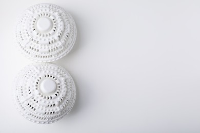 Laundry dryer balls on white table, flat lay. Space for text