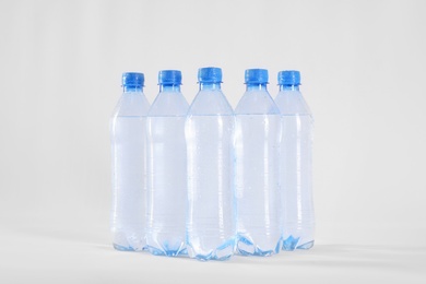 Plastic bottles with pure water on white background
