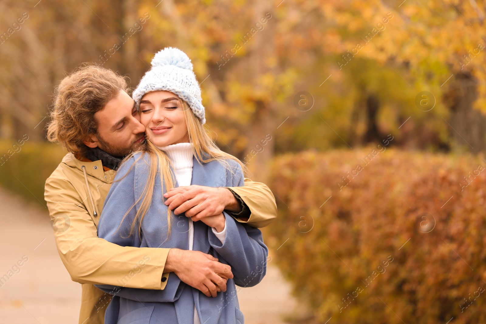 Photo of Young romantic couple in park on autumn day