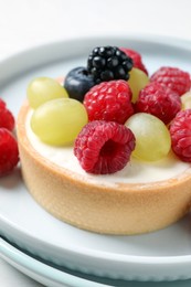 Delicious tartlet with berries on plate, closeup