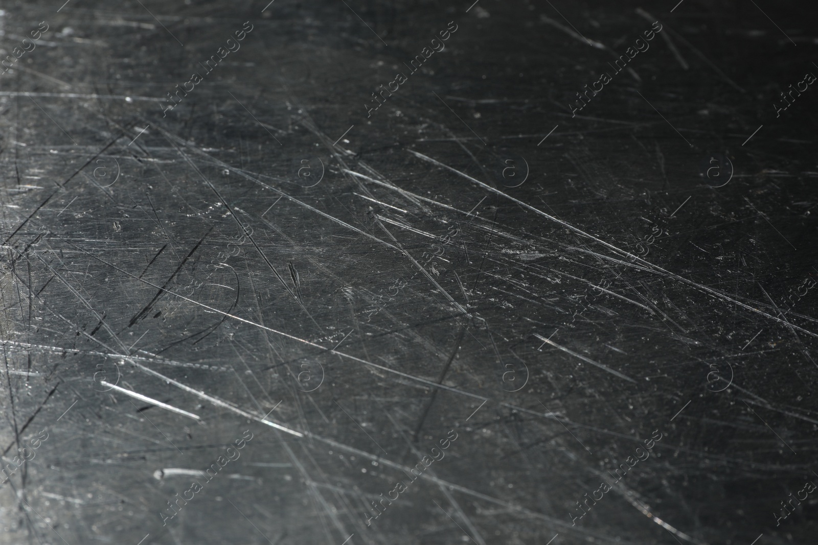 Photo of Texture of scratched metallic surface as background, closeup