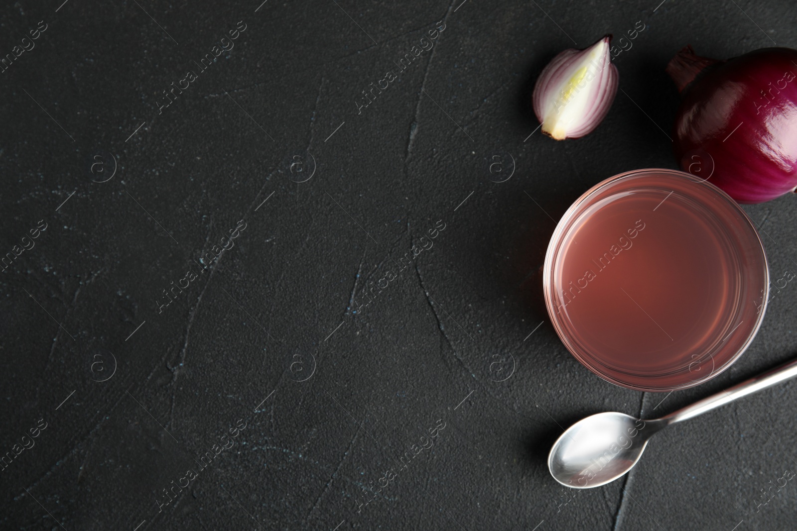 Photo of Flat lay composition with onion syrup in bowl and space for text on table