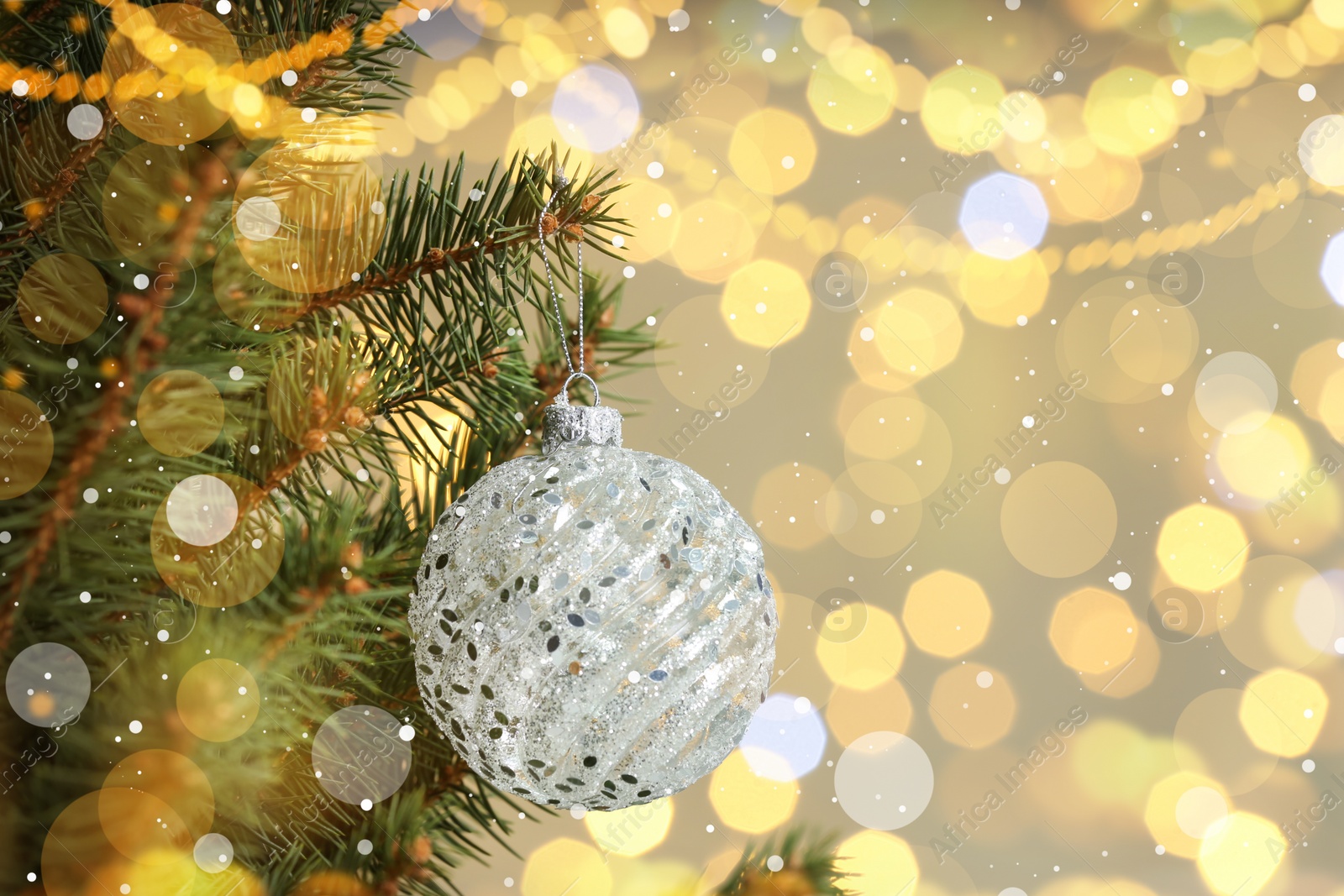 Image of Beautiful bauble hanging on Christmas tree against blurred lights, closeup view with space for text. Bokeh effect