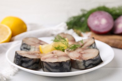 Photo of Slices of tasty salted mackerel on white table, closeup