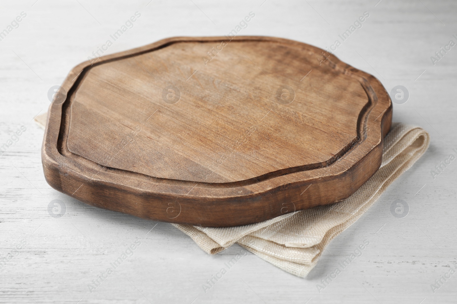 Photo of Kitchen towel and cutting board on white wooden table