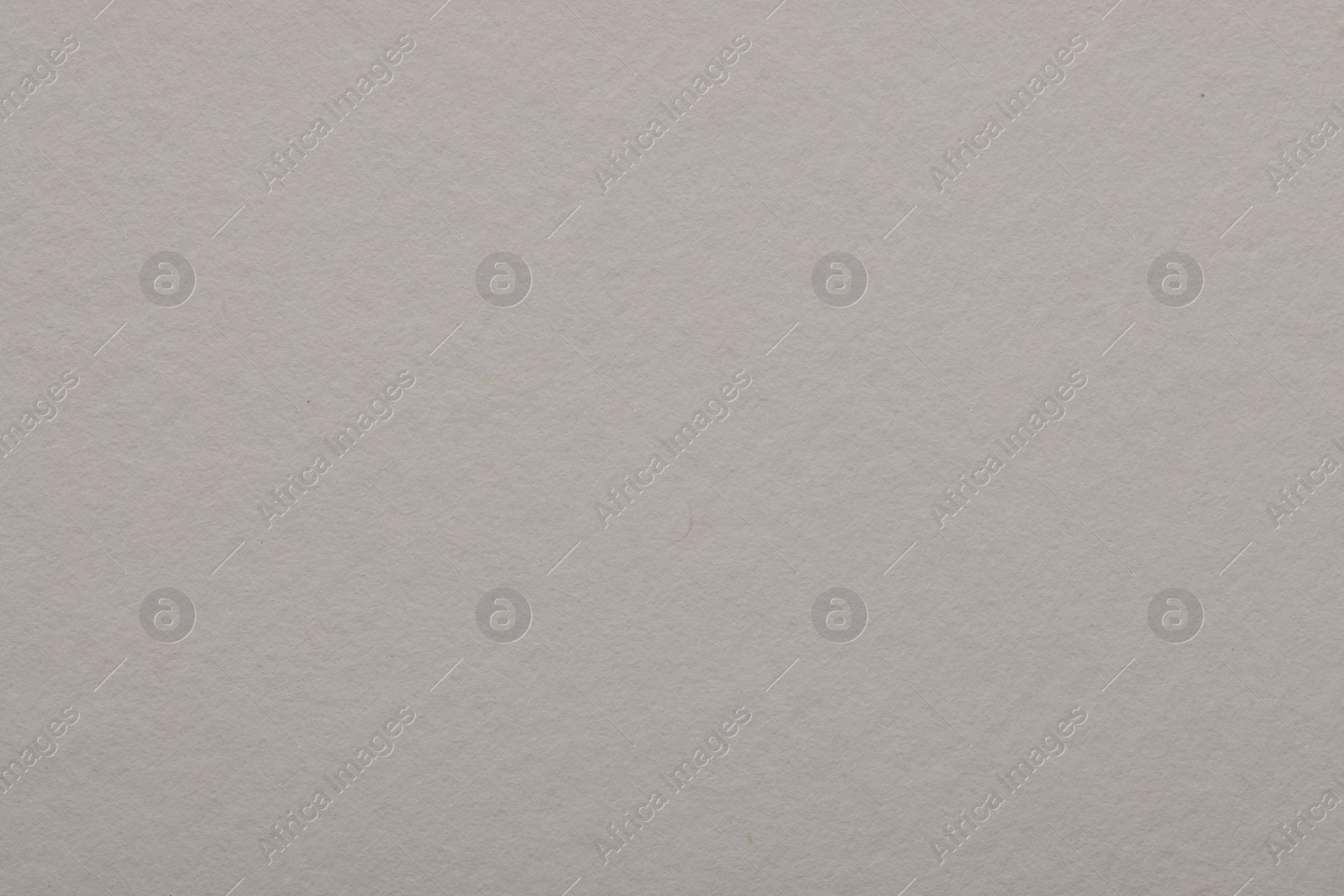 Photo of Texture of light grey paper sheet as background, top view