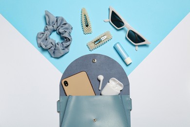 Photo of Stylish women's bag and different stuff on color background, flat lay