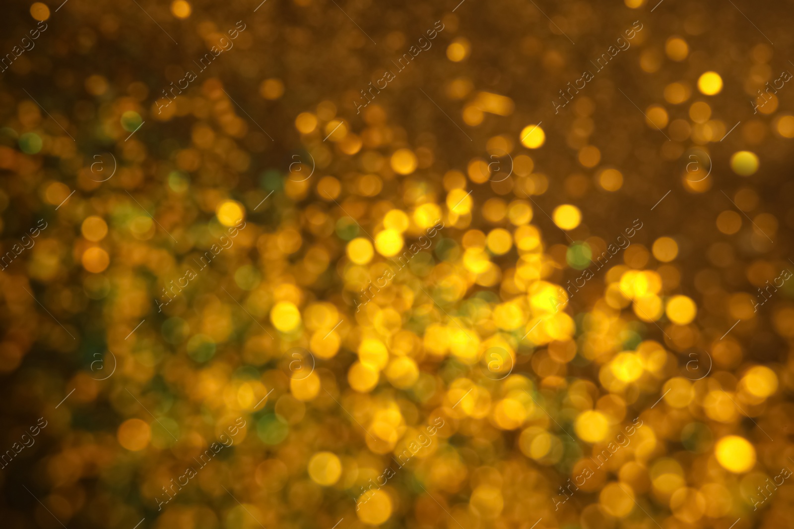 Photo of Blurred view of golden glitter as background. Bokeh effect