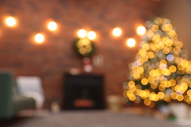 Blurred view of beautiful Christmas tree with lights in living room