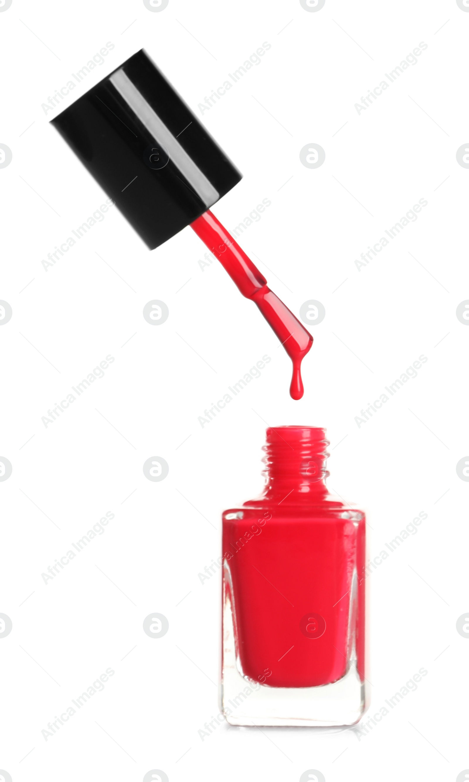 Photo of Brush over nail polish bottle on white background