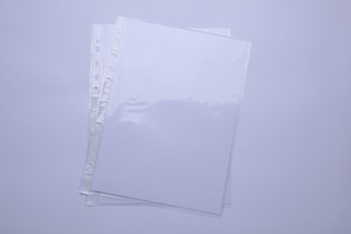Photo of Punched pockets with paper sheets isolated on white, top view