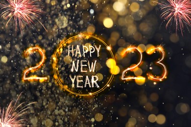 Image of Bright text Happy New 2023 Year made of firework on dark background. Greeting card design