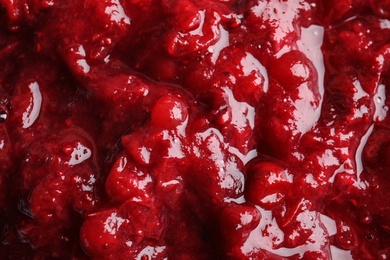 Tasty cranberry sauce as background, closeup view