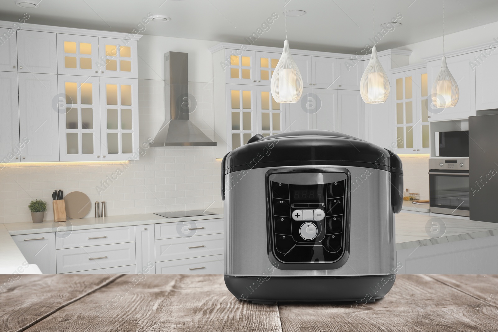 Image of Modern electric multi cooker on wooden table in kitchen. Space for design